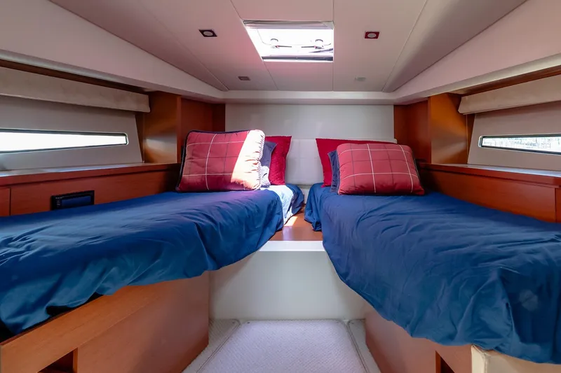 Slide: The Image of Luxurious twin cabin interior of 2015 Prestige 450S yacht with blue bedding and red pillows. - 31