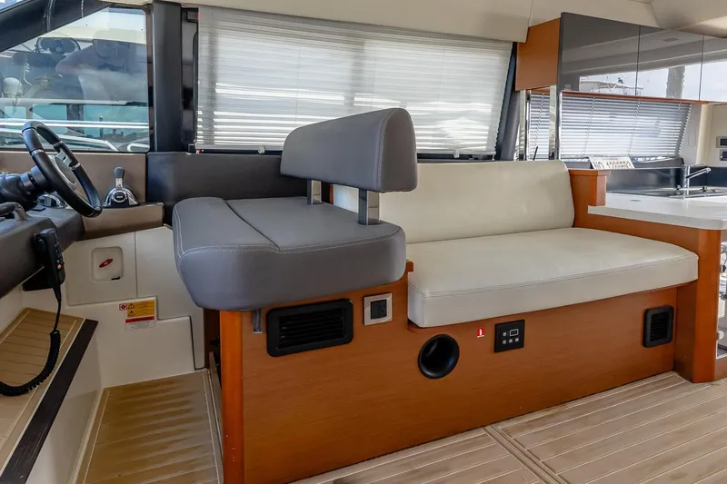 Slide: The Image of Interior of a 2015 Prestige 450S yacht with modern seating and controls. - 21