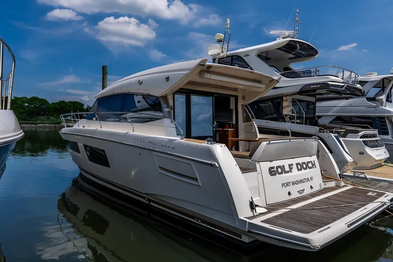 Slide: The Image of Luxury 2015 Prestige 450S yacht docked at marina under blue sky. - 3