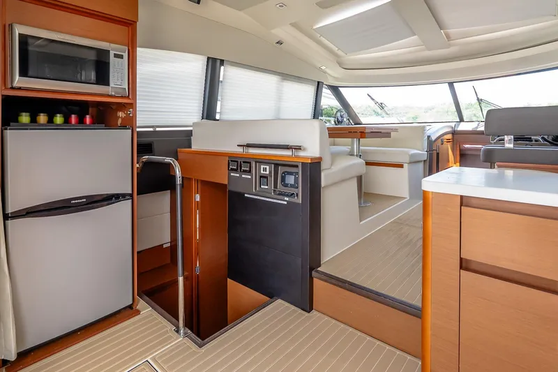 Slide: The Image of Luxurious interior of a 2015 Prestige 450S yacht with modern kitchen and seating area. - 14