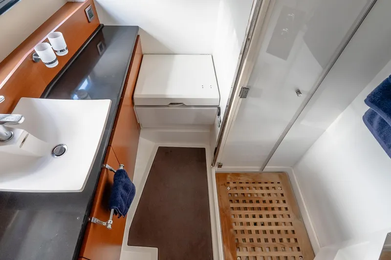Slide: The Image of Modern bathroom in 2015 Prestige 450S yacht with sink, shower, and wooden mat. - 29
