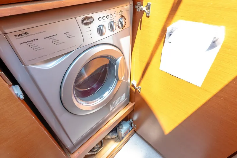 Slide: The Image of Compact washer-dryer unit in wooden cabinet on a 2015 Prestige 450S yacht. - 36