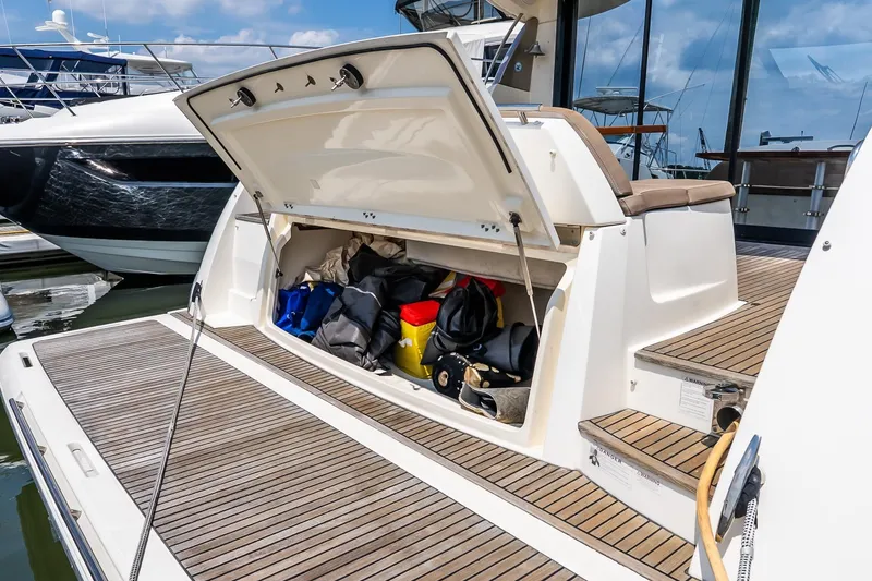 Slide: The Image of 2015 Prestige 450S yacht with open storage compartment, docked at marina. - 5