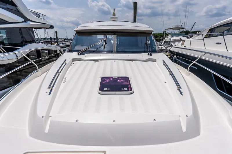 Slide: The Image of 2015 Prestige 450S yacht docked, showcasing sleek design and spacious deck under a cloudy sky. - 41