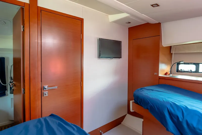 Slide: The Image of Interior cabin of 2015 Prestige 450S yacht with wooden finishes and blue bedding. - 33