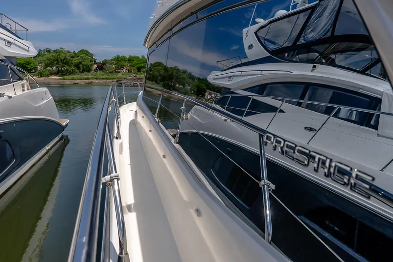 Slide: The Image of Luxury yacht Prestige 450S, 2015 model, docked in a serene marina setting. - 40