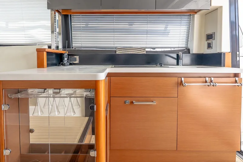 Slide: The Image of Modern kitchen interior of 2015 Prestige 450S yacht with wooden cabinetry and glassware storage. - 13