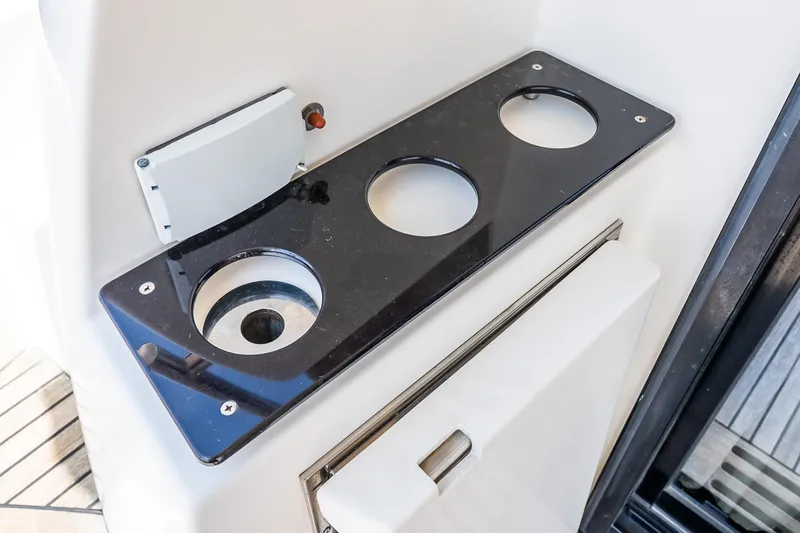 Slide: The Image of Cup holder panel on a 2015 Prestige 450S yacht, featuring three circular slots. - 9