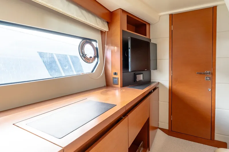Slide: The Image of Luxurious interior of a 2015 Prestige 450S yacht with wood finishes and modern amenities. - 28