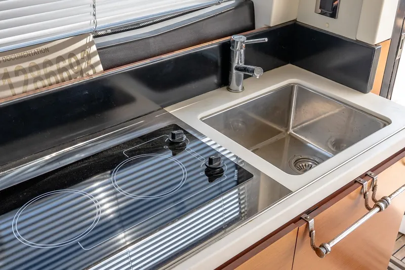 Slide: The Image of Modern kitchen area in a 2015 Prestige 450S yacht with stove and sink. - 18