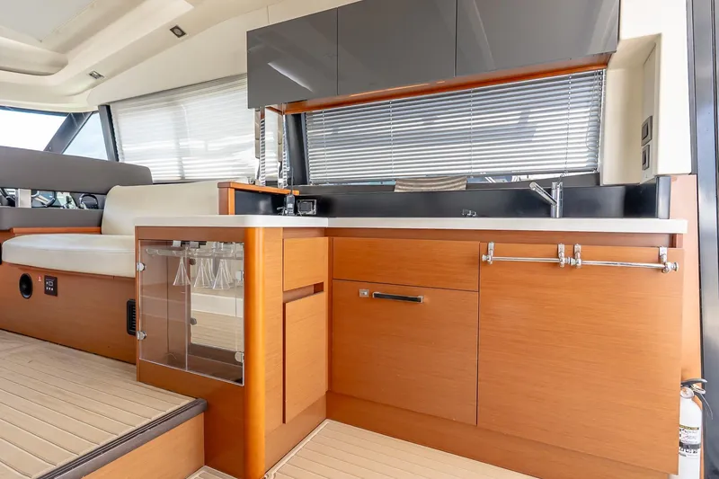 Slide: The Image of Luxurious kitchen interior of 2015 Prestige 450S yacht with modern cabinetry and seating. - 12