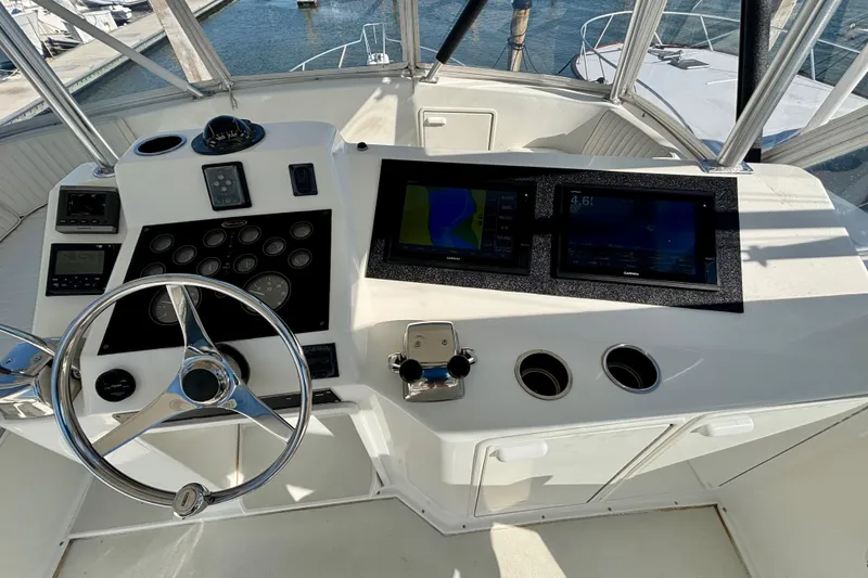 Slide: The Image of Cockpit of 1999 Ocean Yachts 45 Super Sport with steering wheel and navigation displays. - 24