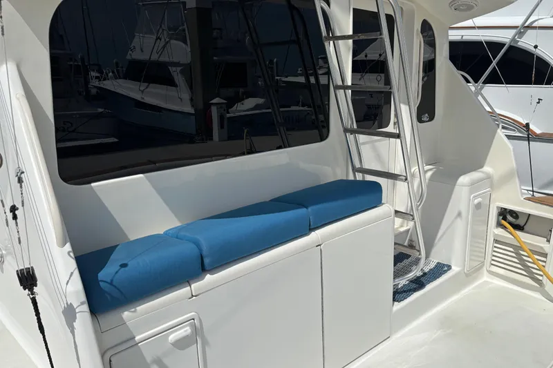 Slide: The Image of 1999 Ocean Yachts 45 Super Sport boat interior with blue cushioned seating and ladder. - 8
