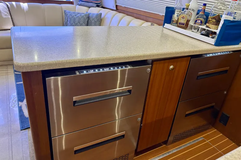 Slide: The Image of Luxurious interior of 1999 Ocean Yachts 45 Super Sport with modern cabinetry and bar setup. - 13