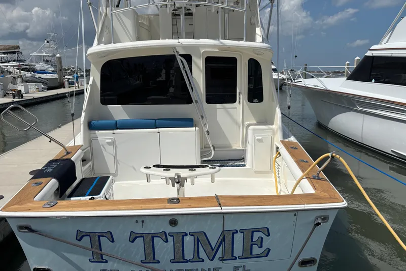 Slide: The Image of 1999 Ocean Yachts 45 Super Sport docked at marina, rear view with fishing setup. - 7