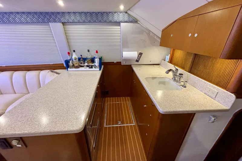 Slide: The Image of Luxurious 1999 Ocean Yachts 45 Super Sport interior with modern kitchen and bar area. - 12
