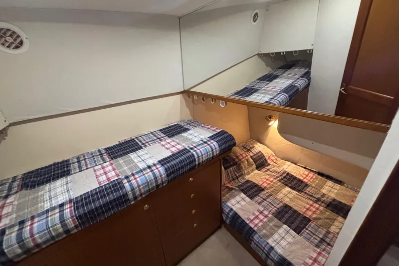 Slide: The Image of Cabin interior of 1999 Ocean Yachts 45 Super Sport with plaid bedding and wooden cabinetry. - 20
