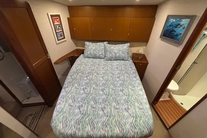 Slide: The Image of Bedroom interior of 1999 Ocean Yachts 45 Super Sport with bed and wooden cabinets. - 17