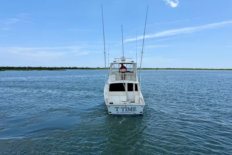 Slide: The Image of Ocean Yachts 1999 model 45 Super Sport cruising on calm waters under a clear sky. - 6