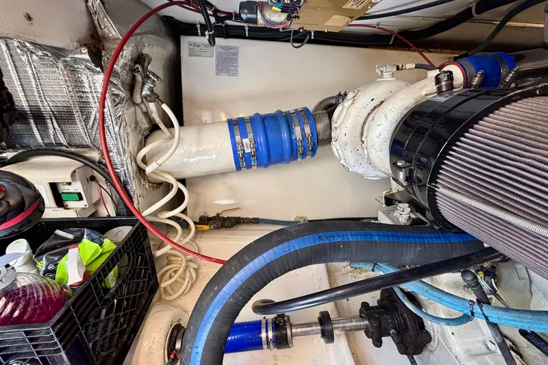 Slide: The Image of Engine room of 1999 Ocean Yachts 45 Super Sport with visible hoses and components. - 29