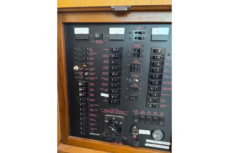 Slide: The Image of Electrical panel of a 1999 Ocean Yachts 45 Super Sport, showcasing various switches and gauges. - 34
