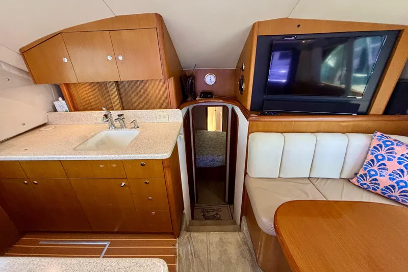 Slide: The Image of Interior of 1999 Ocean Yachts 45 Super Sport with kitchen, seating, and TV. - 11