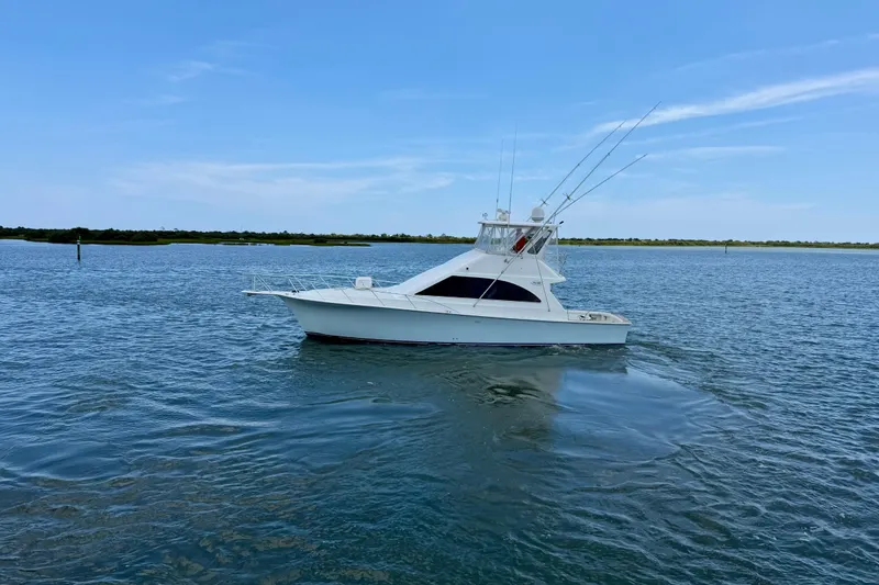Slide: The Image of 1999 Ocean Yachts 45 Super Sport boat on calm water under clear blue sky. - 5