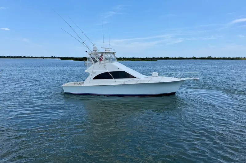 The Image of 1999 Ocean Yachts 45 Super Sport boat on calm water under clear blue sky. - 0