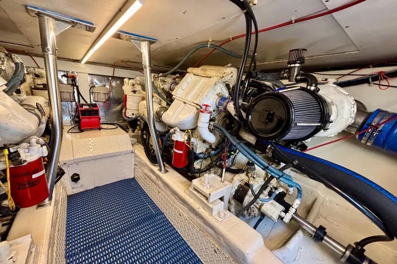 Slide: The Image of Engine room of a 1999 Ocean Yachts 45 Super Sport, showcasing mechanical components and systems. - 28