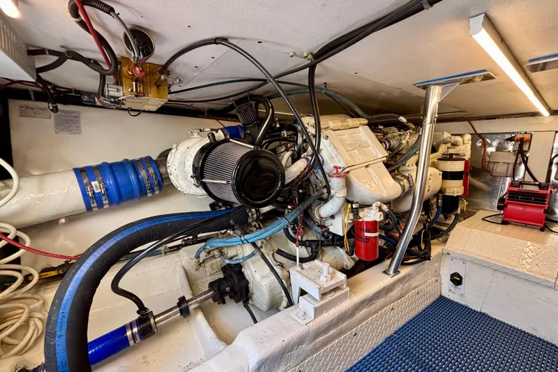 Slide: The Image of Engine room of 1999 Ocean Yachts 45 Super Sport, showcasing complex machinery and components. - 27