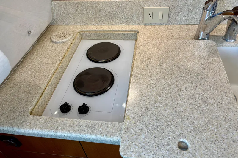 Slide: The Image of 1999 Ocean Yachts 45 Super Sport kitchen with electric stove and granite countertop. - 15