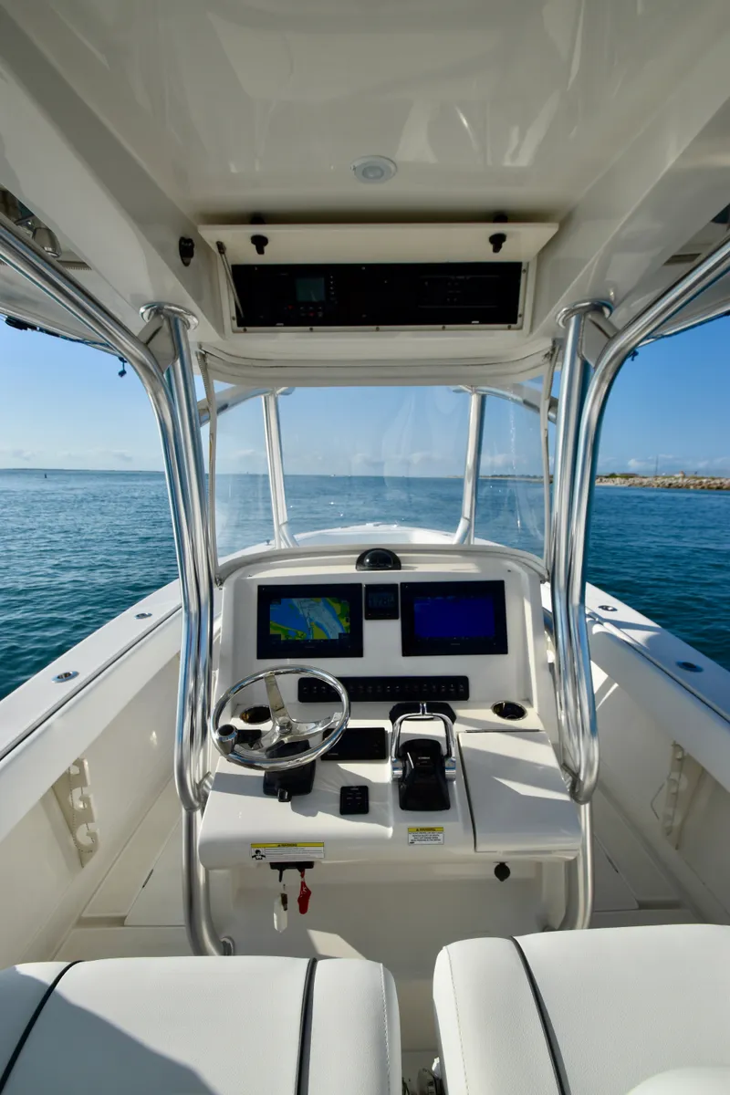 Slide: The Image of The image shows the cockpit of a 2015 Jupiter Center Console boat with modern electronics. - 22
