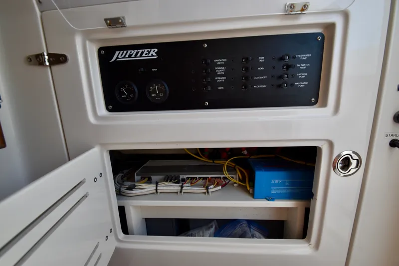 Slide: The Image of The image shows the dashboard of a 2015 Jupiter Center Console boat with switches and wiring. - 40