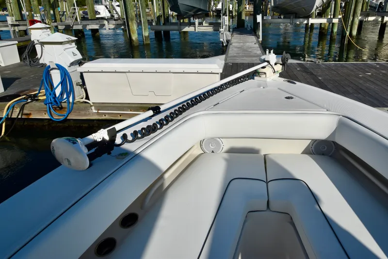 Slide: The Image of 2015 Jupiter Center Console at dock with cushioned seating and fishing rod holder. - 25