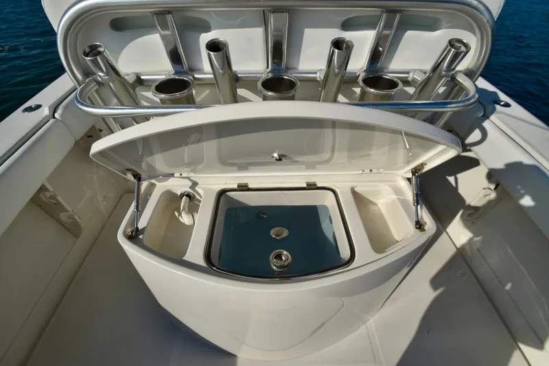Slide: The Image of A 2015 Jupiter Center Console featuring an open livewell and multiple rod holders. - 14