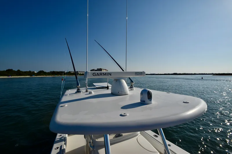 Slide: The Image of A 2015 Jupiter Center Console boat on the water with Garmin equipment. - 18