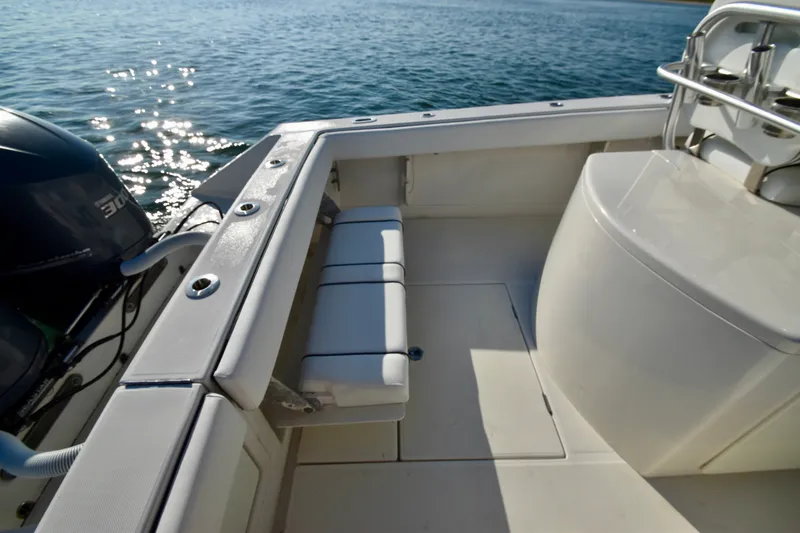 Slide: The Image of A 2015 Jupiter Center Console boat with a clean deck and a bench seat at the stern. - 13