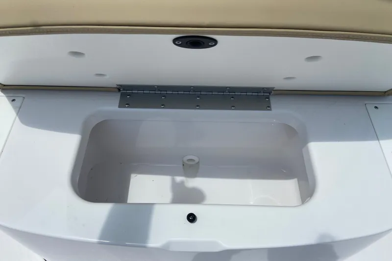 Slide: The Image of An open storage compartment on a 2026 Sportsman Heritage 261 Center Console boat. - 31