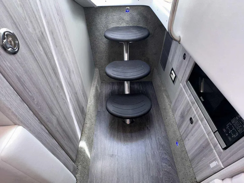 Slide: The Image of Interior with gray wood paneling and three black steps. Built-in appliances are visible. - 48