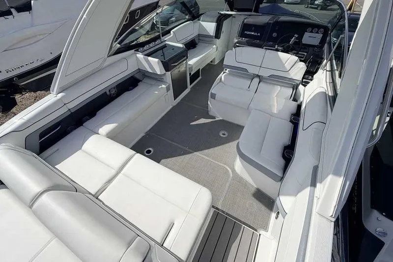 Slide: The Image of 2022 Formula 330 Crossover Bowrider I/O interior with luxurious seating and modern dashboard. - 12