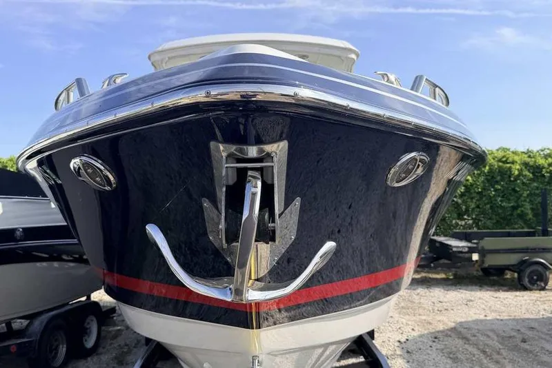 Slide: The Image of 2022 Formula 330 Crossover Bowrider I/O boat, front view with anchor, outdoors. - 5