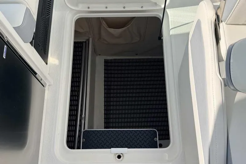 Slide: The Image of 2022 Formula 330 Crossover Bowrider I/O storage compartment with rubber matting. - 36