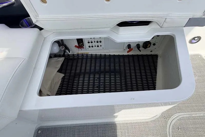 Slide: The Image of Open storage compartment in 2022 Formula 330 Crossover Bowrider I/O boat. - 23