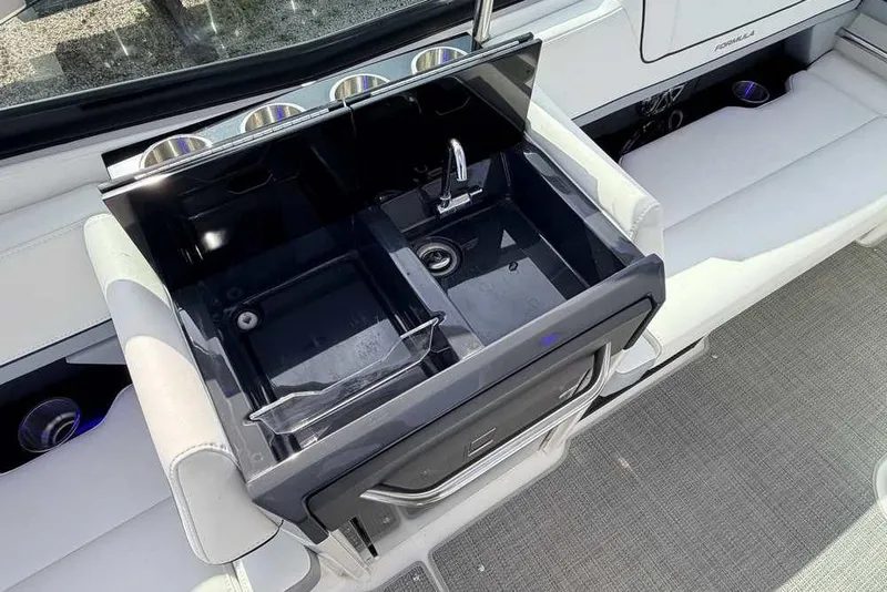 Slide: The Image of 2022 Formula 330 Crossover Bowrider I/O featuring a sleek onboard sink and seating area. - 16