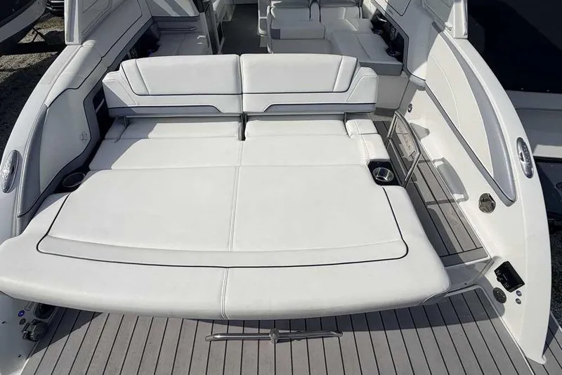 Slide: The Image of 2022 Formula 330 Crossover Bowrider I/O with spacious white seating and sleek design. - 8