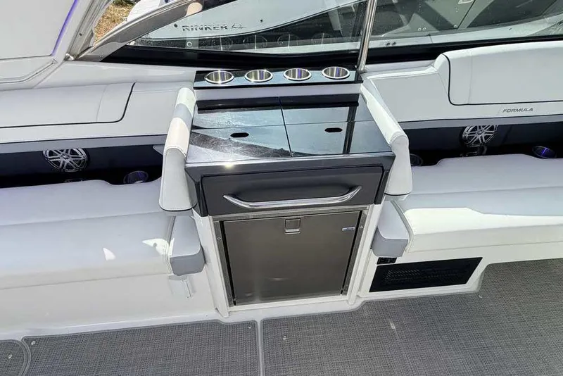 Slide: The Image of 2022 Formula 330 Crossover Bowrider I/O interior with sleek seating and built-in cup holders. - 15