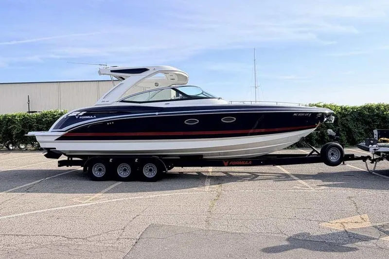 Slide: The Image of 2022 Formula 330 Crossover Bowrider I/O on trailer in parking lot. - 4