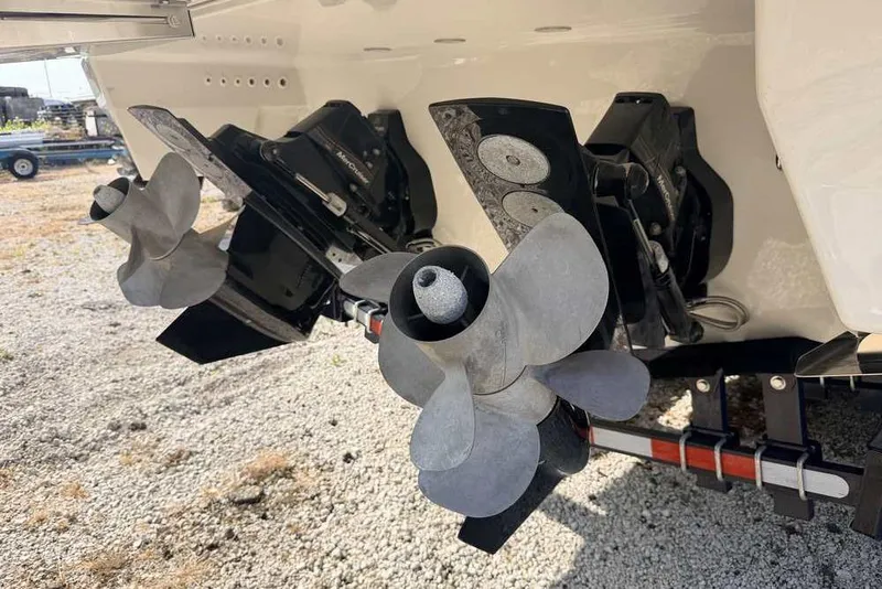 Slide: The Image of Close-up of 2022 Formula 330 Crossover Bowrider I/O propellers on gravel surface. - 61