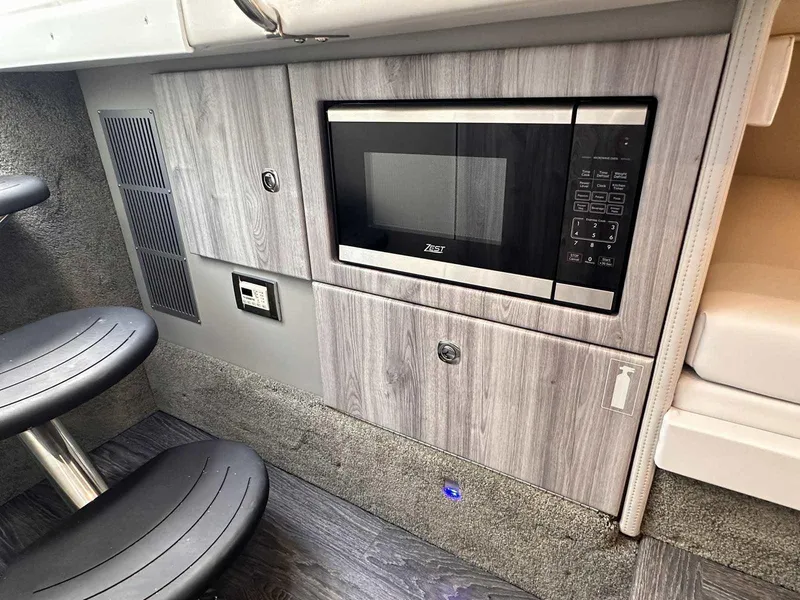 Slide: The Image of The interior view shows a modern microwave in a sleek wood cabinet with gray accents. - 49