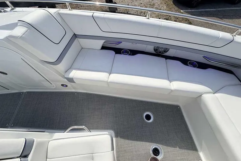 Slide: The Image of 2022 Formula 330 Crossover Bowrider I/O interior with white seating and gray flooring. - 44